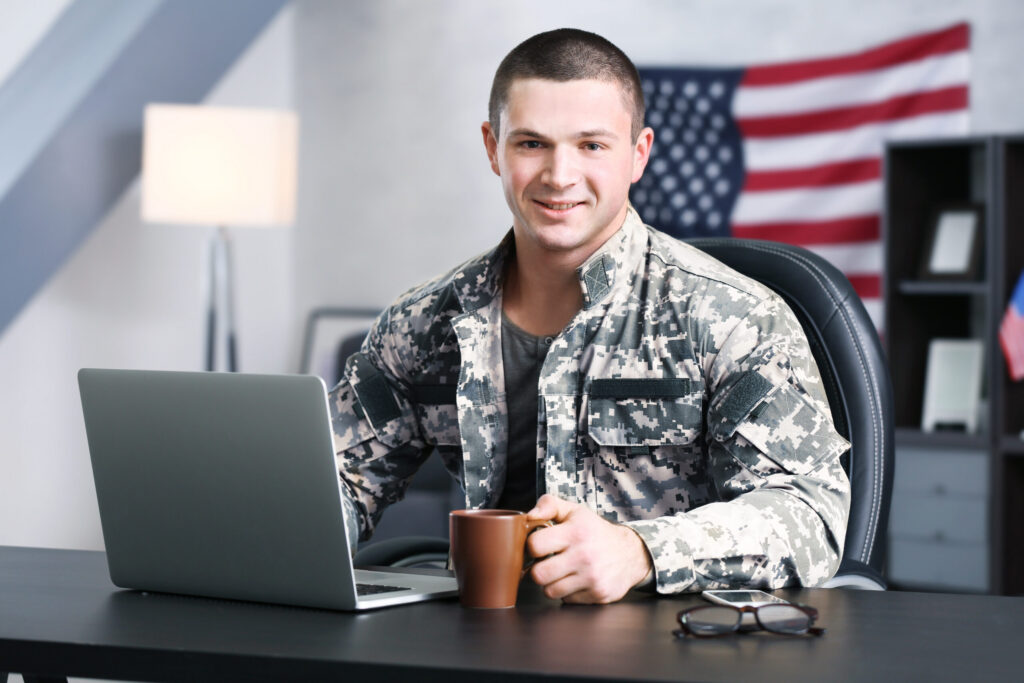 Service member working on a laptop