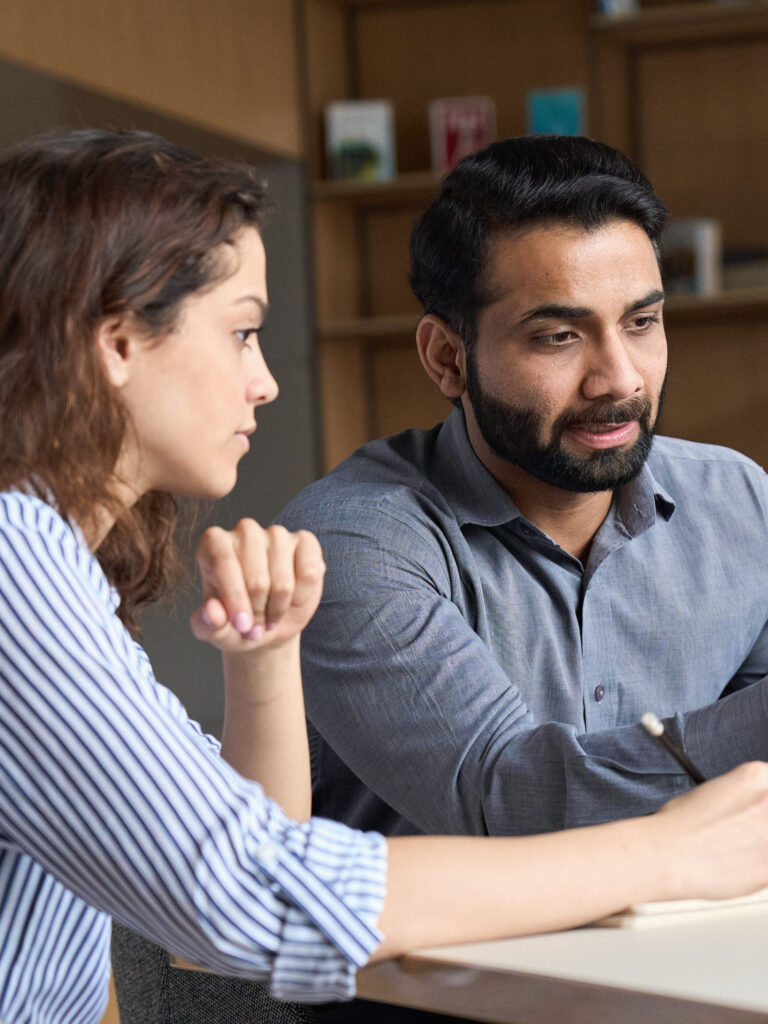 Two adult learners studying together at a table