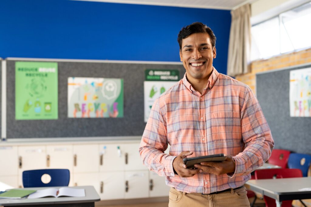 Teacher smiling in his classroom